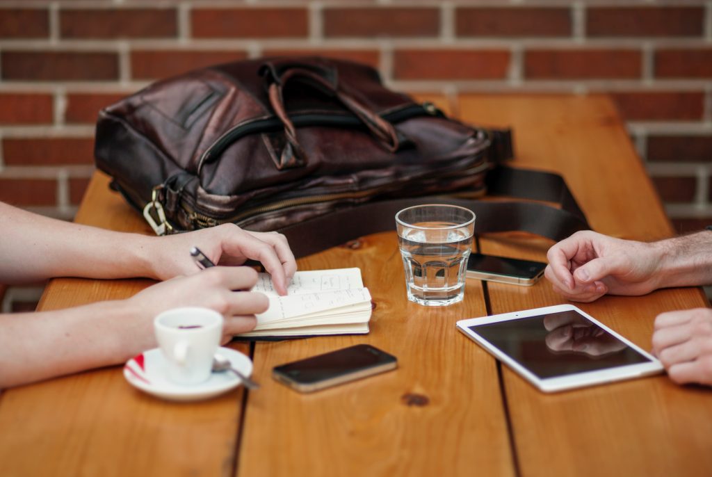 Two people are sitting at a table talking