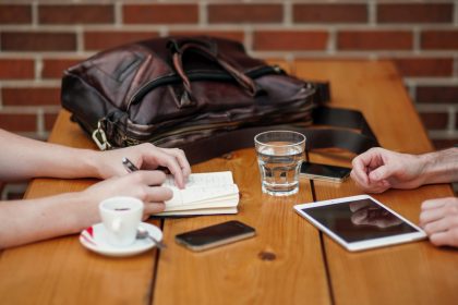 Two people are sitting at a table talking