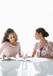 2 Woman sitting at a table and talking