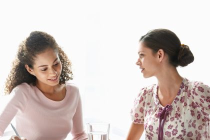 2 Woman sitting at a table and talking