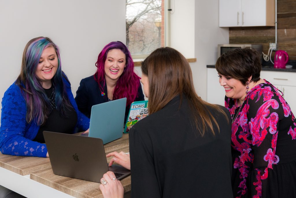 A group of ladies are sitting round a table and talking