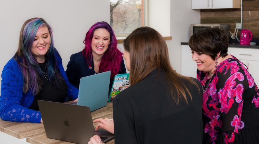 A group of ladies are sitting round a table and talking