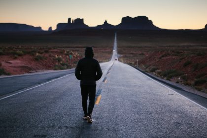 A man is following his path down a road