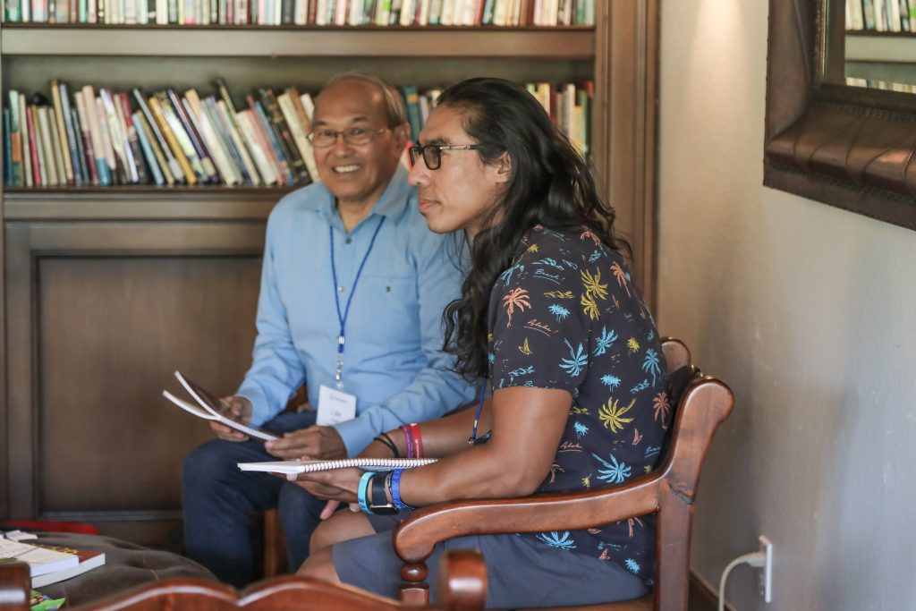 A man and a women are sitting in an office and talking