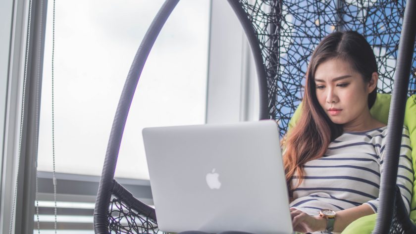 Benefits of Coaching for Individuals A girls is sitting g in a chair with a laptop computer