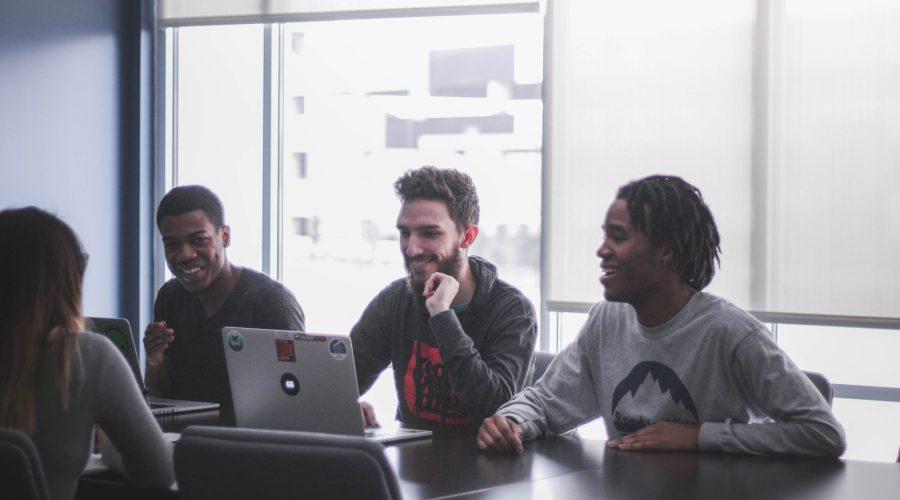 A group of people, men and woman, are sitting talking