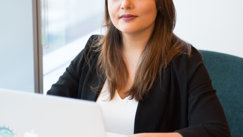 Transform Your Life. Embrace Coaching as a Career A woman is sitting at a table with her laptop computer open.