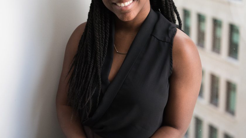 Transform Your Life. Embrace Coaching as a Career, Part 1 An African American woman is sitting with a book in her hand