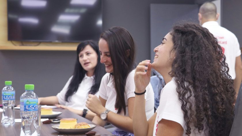 Essential Coaching Skills Every Leader Can Use Today A group of ladies are sitting at tables talking