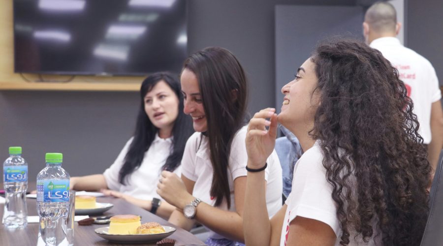 A group of ladies are sitting at tables talking
