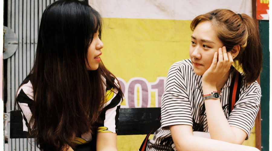 2 ladies are sitting and talking