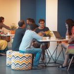 Coach Training That Works (How To Build Real Skills Not Just Hype) A group of men and woman are sitting and appear to be studying