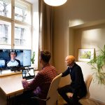2 Men are sitting at a computer on a video call