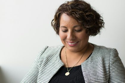 An African American woman is sitting and reading or studying