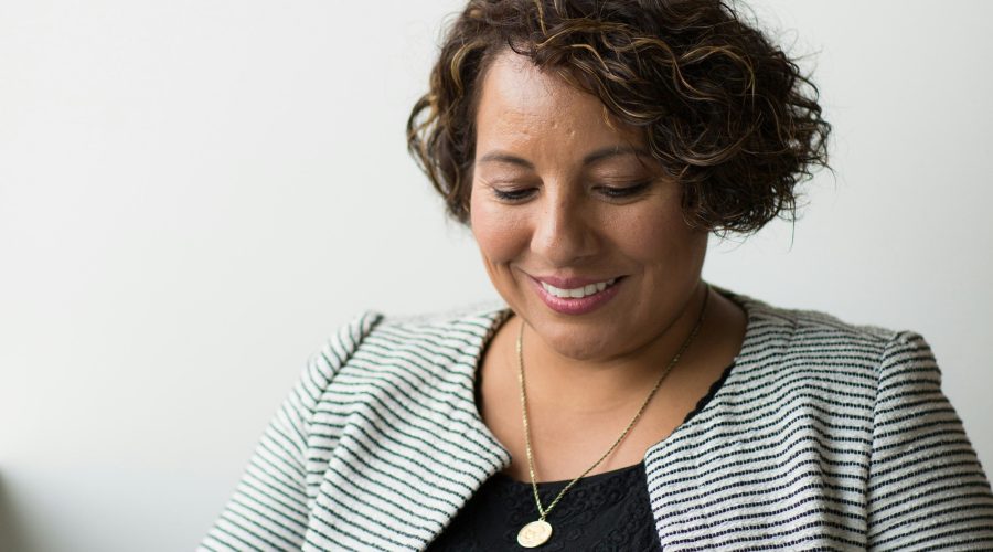 An African American woman is sitting and reading or studying