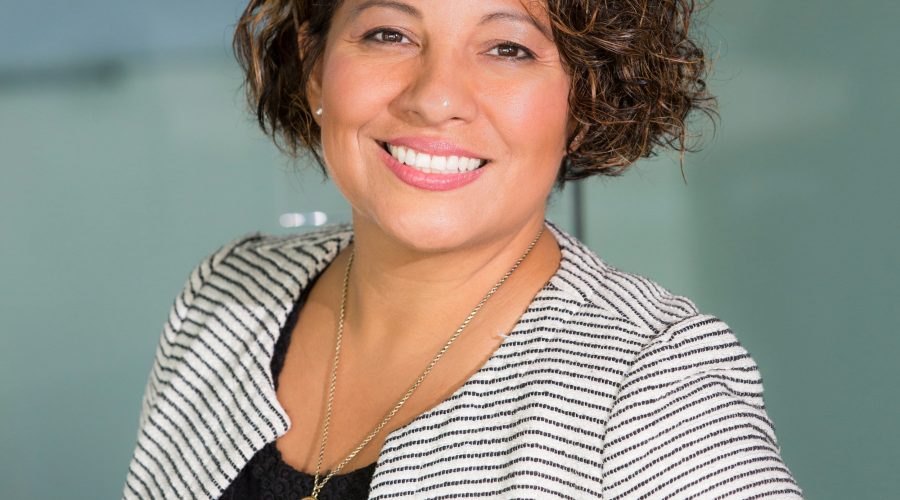 A business woman is standing and looking g at the camera