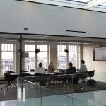 Why Executive Coaches Need Professional Coaching Certification A group of business people are sitting in a conference room