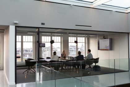 A group of business people are sitting in a conference room
