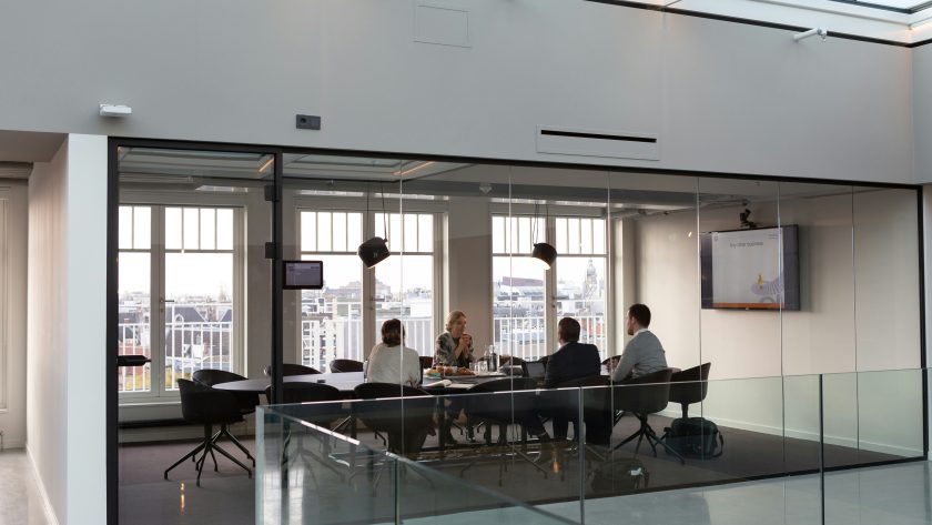 Why Executive Coaches Need Professional Coaching Certification A group of business people are sitting in a conference room
