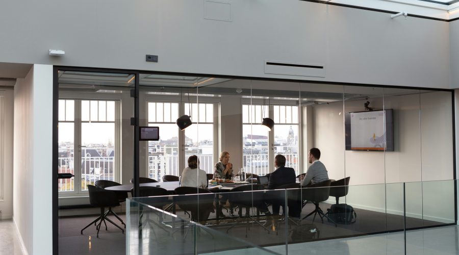 Why Executive Coaches Need Professional Coaching Certification A group of business people are sitting in a conference room