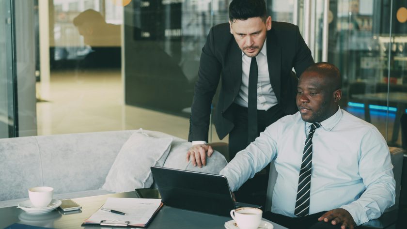 Resilience and Emotional Intelligence (EQ) in Coaching - A Practical Guide for Real Sessions 2 Business men are talking in an office.