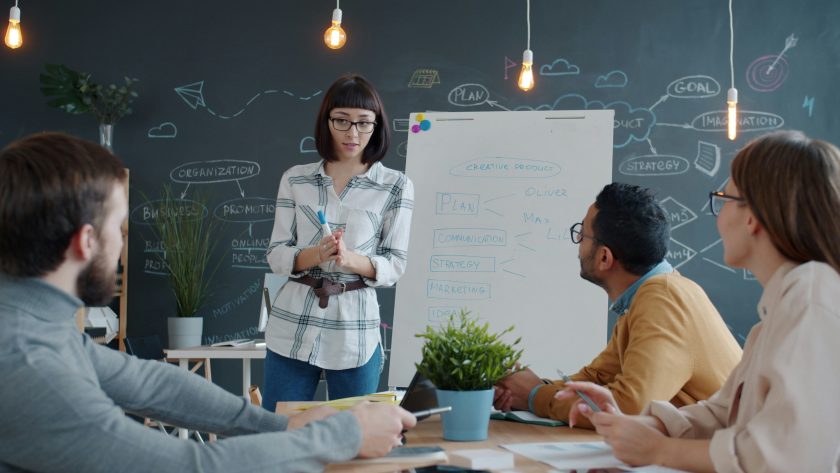 About Coaching Training in the Center for Coaching Certification Level 1 and 2 Programs A group of men and woman are sitting in classroom or conference room and talking or training