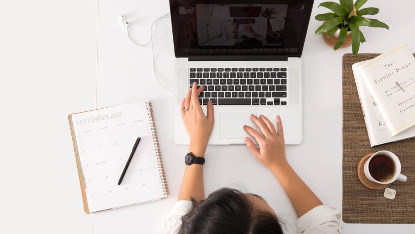 Understanding ICF Coaching Certification- A Professional Guide A woman is sitting at her desk working on her computer