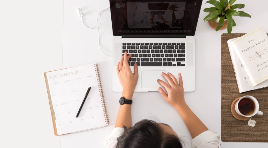 Understanding ICF Coaching Certification- A Professional Guide A woman is sitting at her desk working on her computer