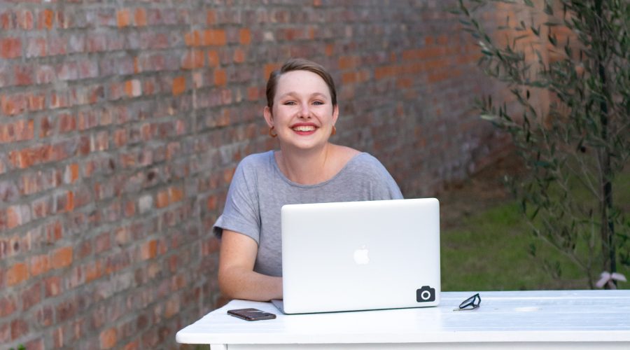 Coaching Certification - An Investment In You A woman is sitting outside with her laptop computer