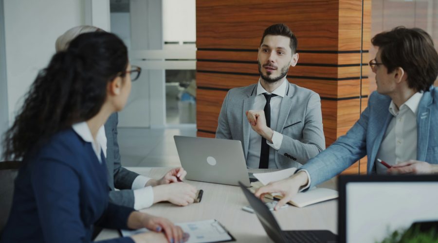 ICF Coaching Certification A group of business people are sitting around a desk talking