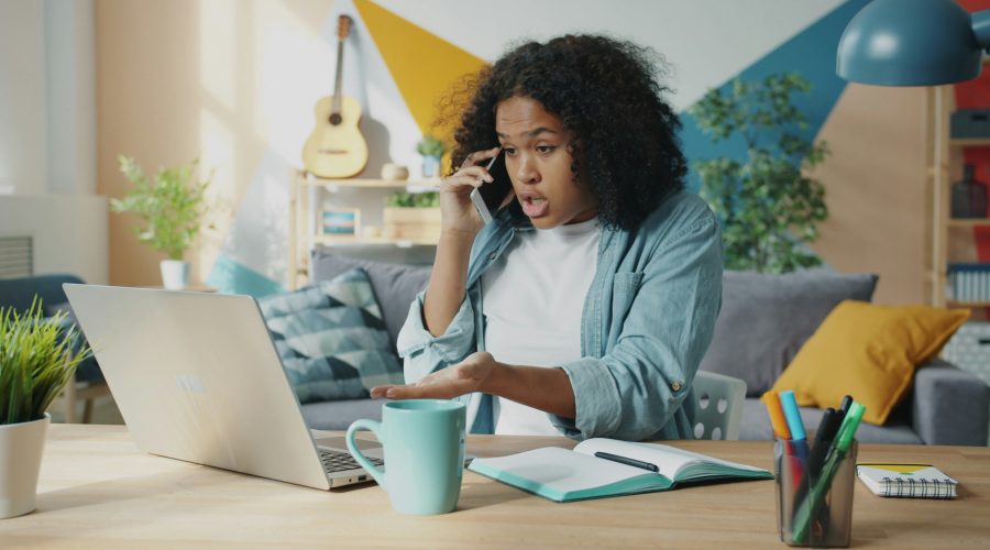 A African American woman is sitting and looks upset or frustrated