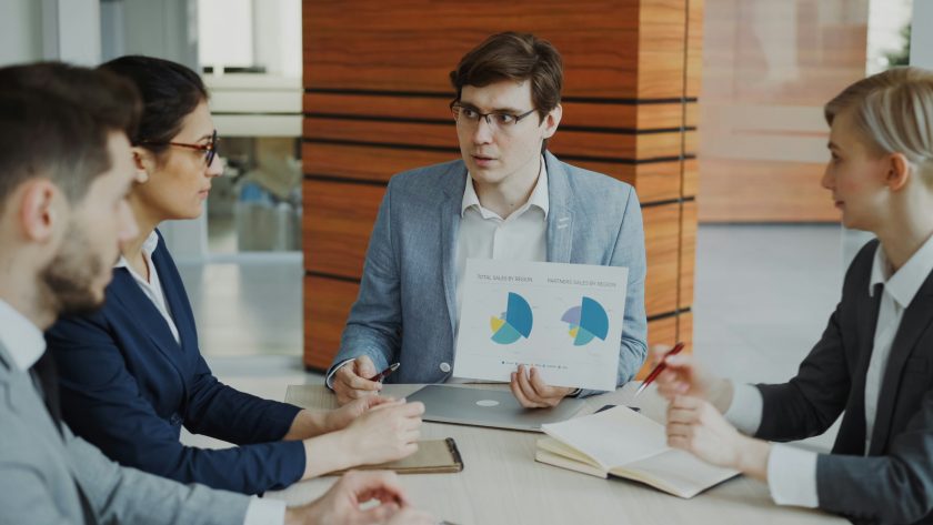 Ethics, Competencies, and PCC Markers Provide the Foundation A group of business men and woman re sitting round a conference table