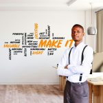 A African American man is sitting in front of a whiteboard
